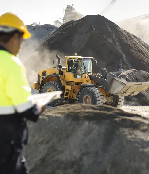 Cinematic shot of Excavator working with job site in view