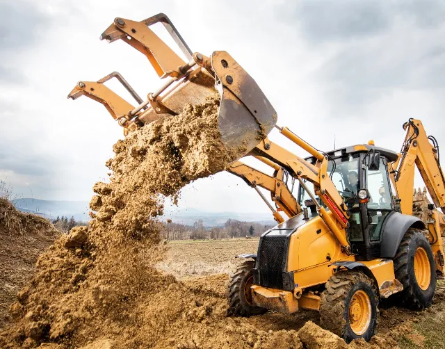 Machine Dumping Dirt Image